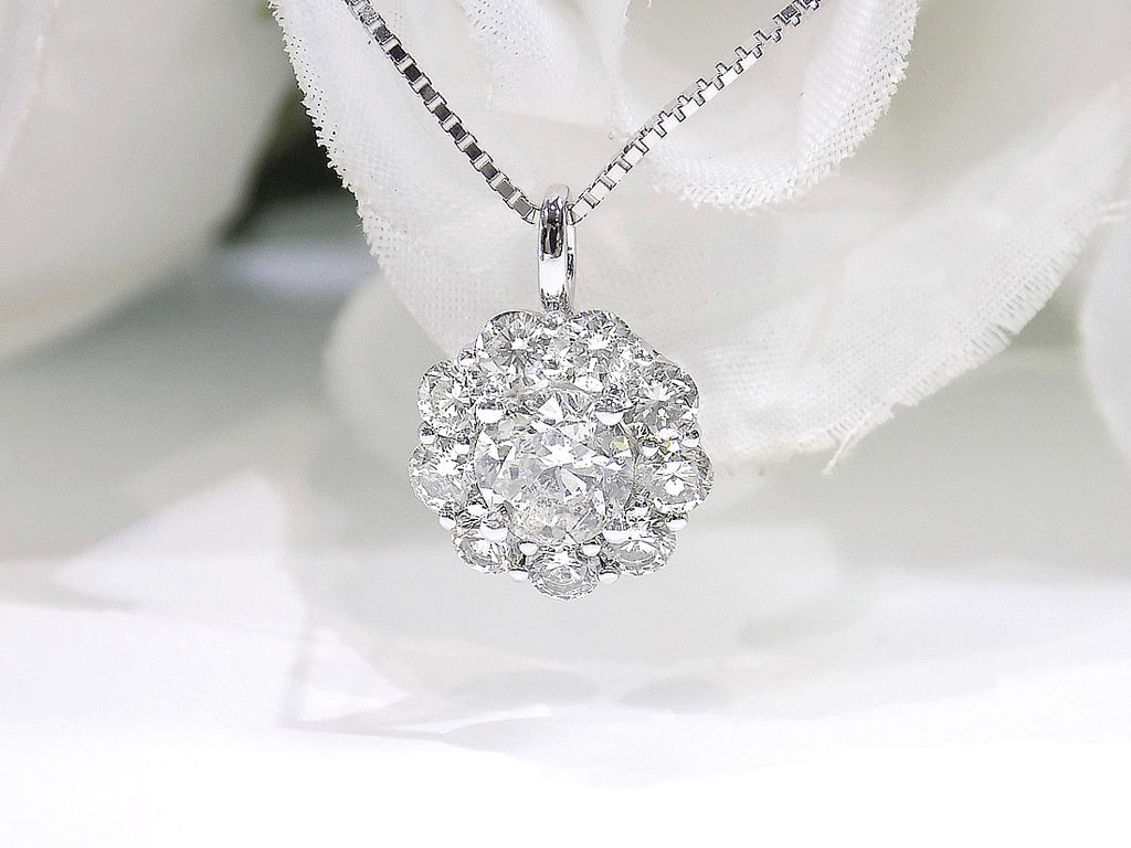 This is a 2.00ct natural round halo style diamond necklace with a 1.00ct center round brilliant diamond and 1.00ct round brilliant diamonds in the halo in 14K white gold with a white background.