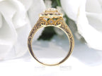 This is a side view of a halo style 2.17ct total weight natural round diamond ring with a 1.52ct center diamond in yellow gold with a white background.