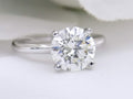 This is a natural 2.51ct round brilliant diamond solitaire in white gold with a white background.