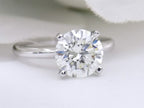 This is a natural 2.51ct round brilliant diamond solitaire in white gold with a white background.