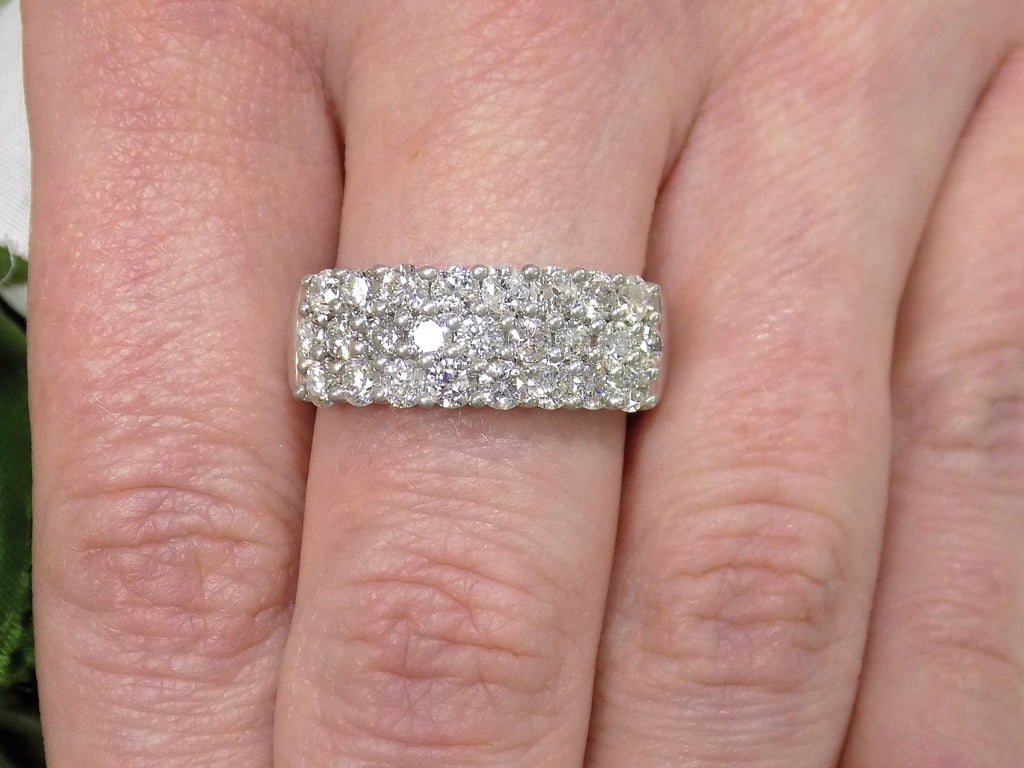 This is an estate 3-row 2.00ct total weight natural diamond band 8.2mm wide in 14K white gold on a woman's finger.