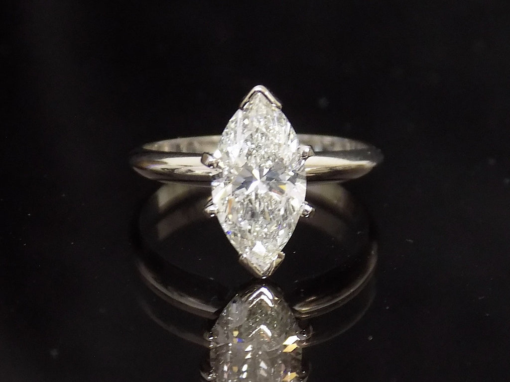 This is a 2.03ct marquise shape diamond solitaire in white gold on black mirrored background.