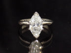 This is a 2.03ct marquise shape diamond solitaire in white gold on black mirrored background.