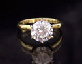 This is a 2.20ct natural round brilliant diamond solitaire in yellow gold with a black mirrored background.