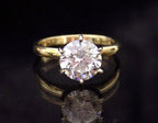 This is a 2.20ct natural round brilliant diamond solitaire in yellow gold with a black mirrored background.