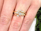This is a custom 2-piece set with a matching band .77ct total weight with .25ct center round brilliant diamond in 14K yellow gold on a ladies finger.
