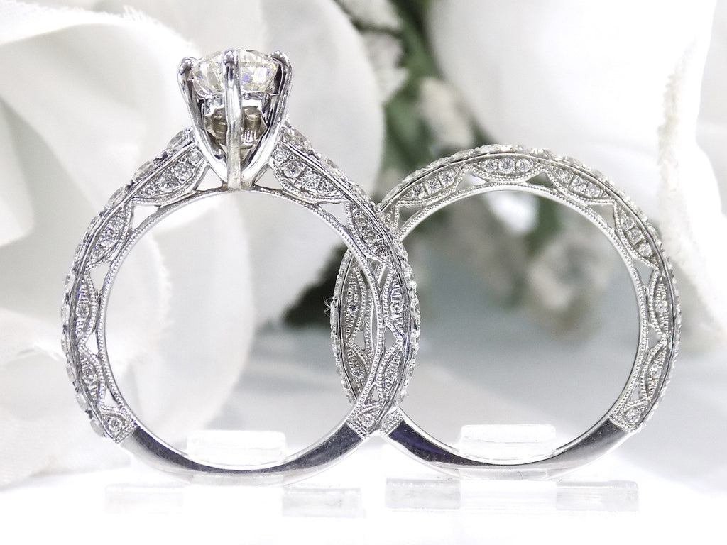 This is a side view of a women's 2-piece wedding set including the engagement ring and a matching band with a 1.51ct natural pear shape diamond center plus 1.64ct in natural diamond accents shown side by side on white background.