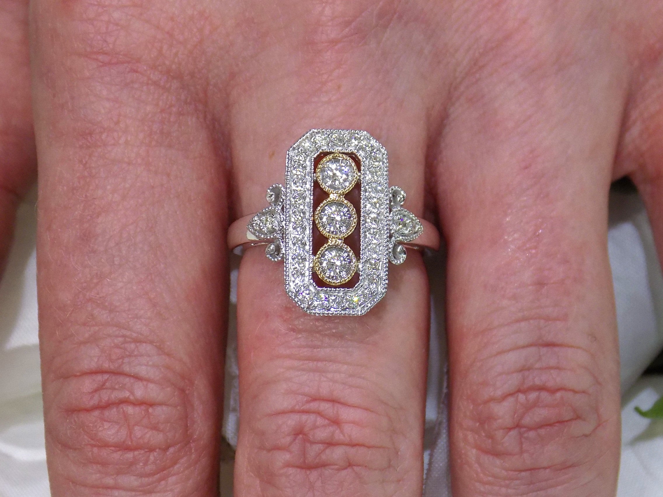 This ring is a filigree style natural diamond ring with a total of .37ct natural diamonds in 2-tone white and yellow gold on a ladies finger.