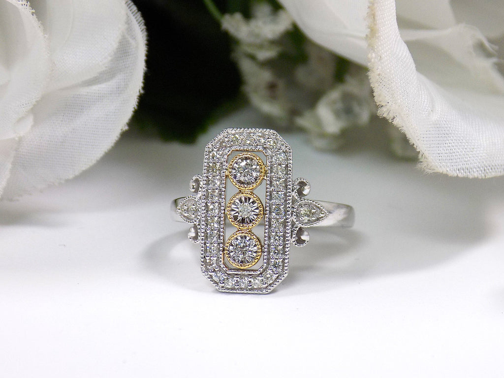 This ring is a filigree style natural diamond ring with a total of .37ct natural diamonds in 2-tone white and yellow gold on a white floral background.