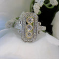 This ring is a filigree style natural diamond ring with a total of .37ct natural diamonds in 2-tone white and yellow gold on a white floral background.