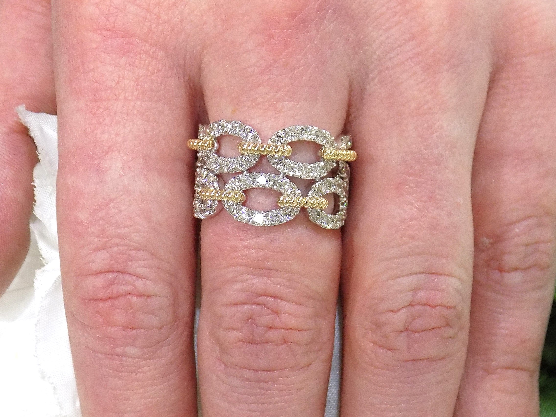 1.50ct double row two tone white and yellow gold natural diamond band on a ladies finger.