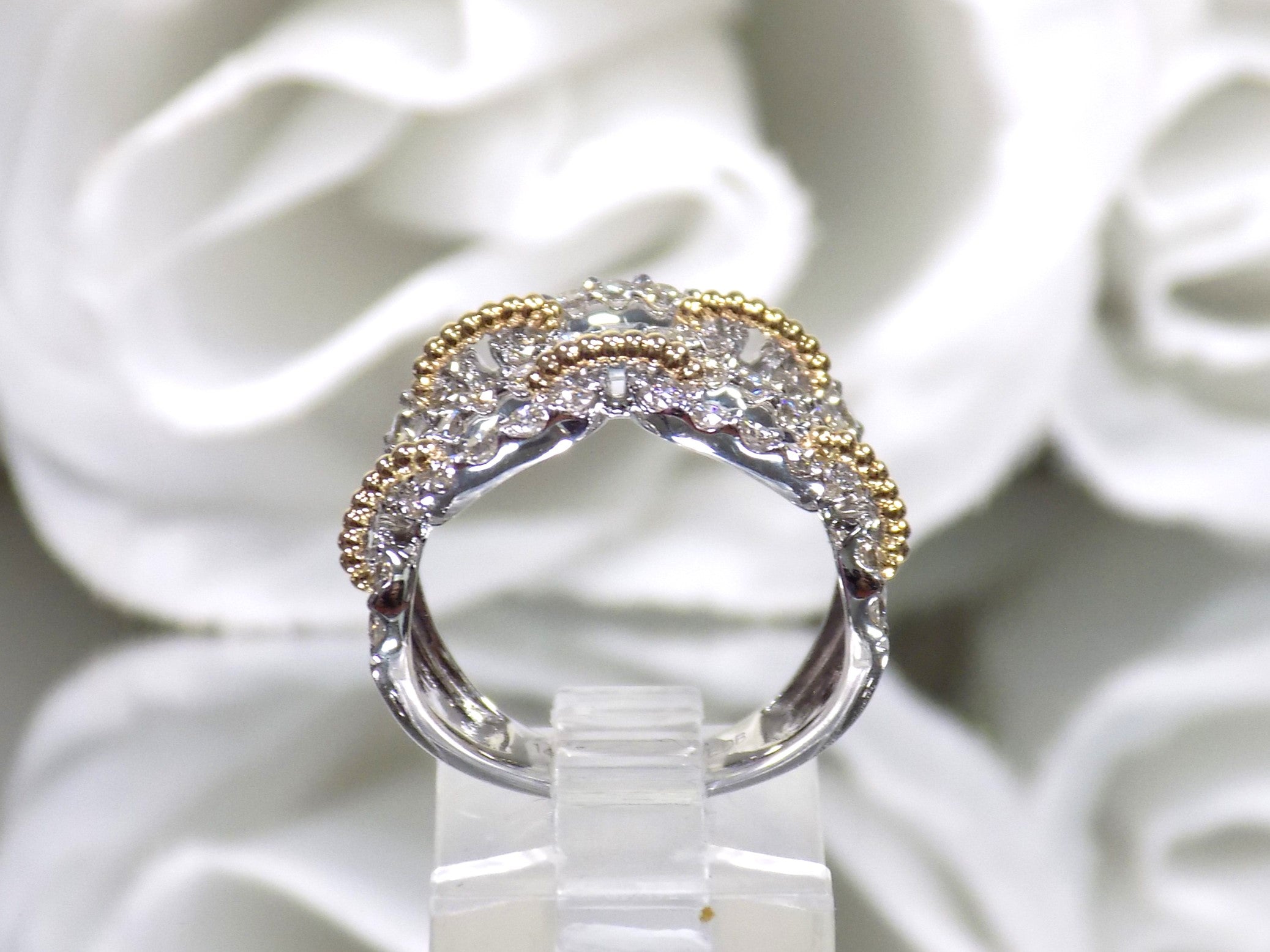 1.50ct double row two tone white and yellow gold natural diamond band from a side view.