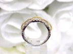 1.50ct double row two tone white and yellow gold natural diamond band from a side view.