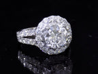 This is 3.55ct total weight natural diamond ring with a 2.05ct natural round diamond center in white gold shown on a mirrored black background.