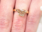 This is a 3.06ct natural GIA certified custom shield cut fancy chocolate diamond solitaire ring in yellow gold shown on a woman's finger.