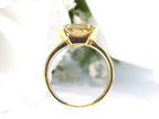 This is a side view of a 3.06ct natural GIA certified custom shield cut fancy chocolate diamond solitaire ring in yellow gold with a white background.