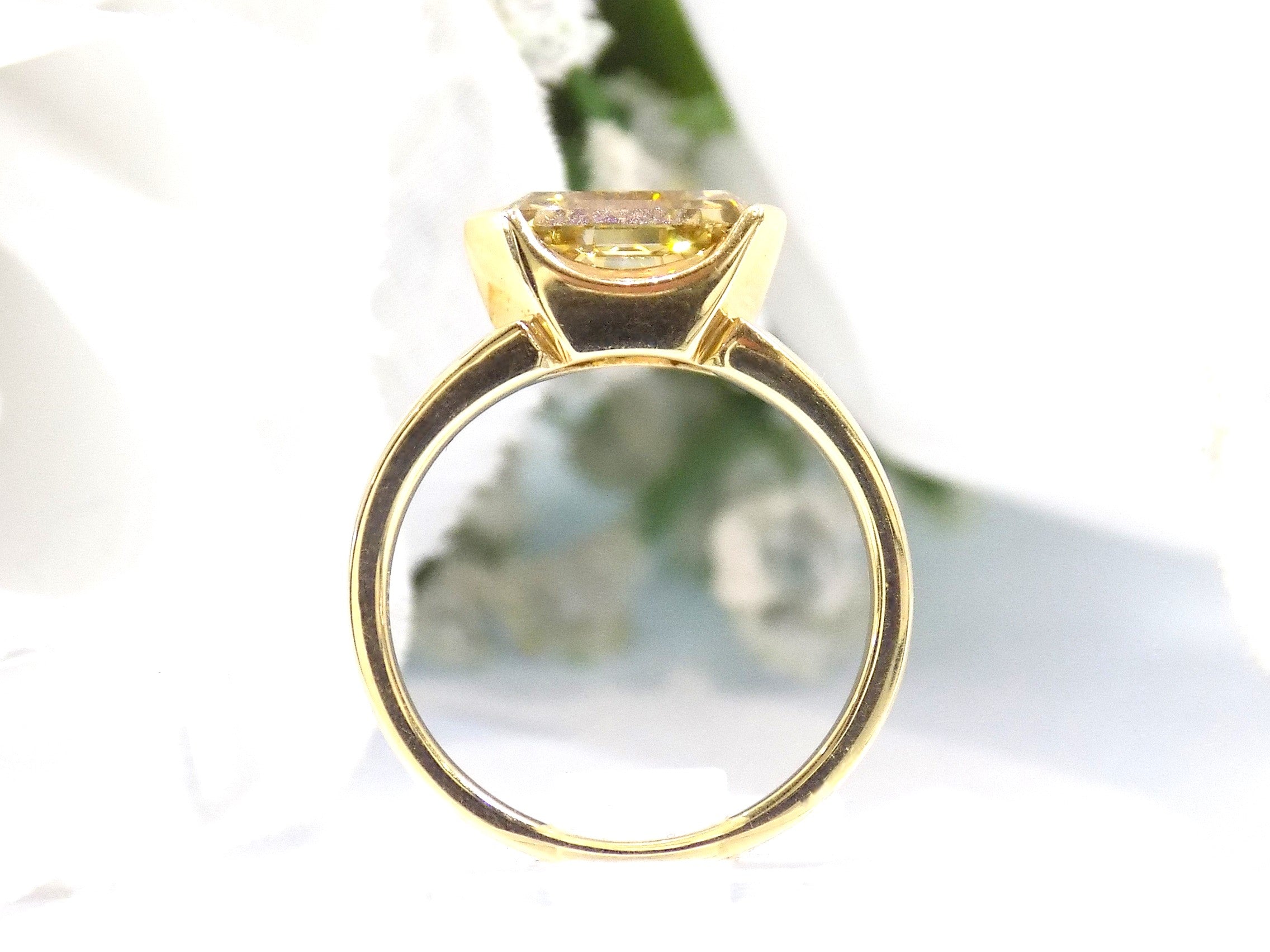 This is a side view of a 3.06ct natural GIA certified custom shield cut fancy chocolate diamond solitaire ring in yellow gold with a white background.