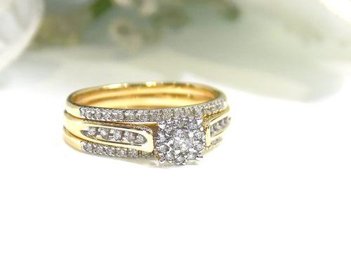This is a halo style 2-piece diamond wedding set with 2 matching bands in yellow gold with white background.