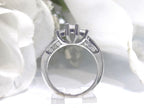 This is a side view 3-Stone style .75ct total weight natural princess cut diamond ring in white gold with white background.