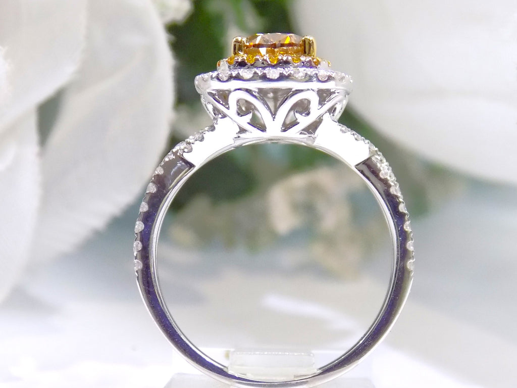 This is a side view of a 1.69ct total weight genuine natural pear shape chocolate diamond ring with canary yellow and white diamond accents in white gold with a white background.