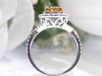 This is a side view of a 1.69ct total weight genuine natural pear shape chocolate diamond ring with canary yellow and white diamond accents in white gold with a white background.