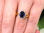 This is a women's estate LeVian ring with a 3.50ct total weight sapphire and diamonds set in 14K yellow gold on a woman's finger.