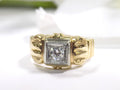 This is an natural antique diamond ring from the turn of the century in yellow and white gold with a white background.