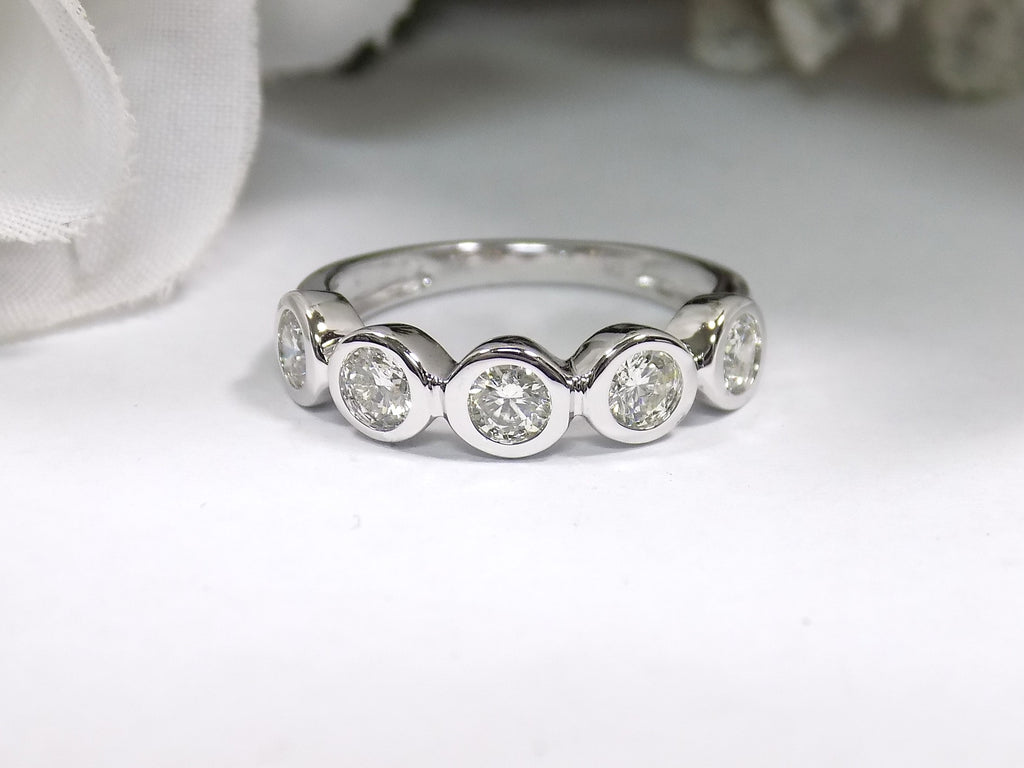 This is a 5 stone bezel set natural round diamond band in 14K white gold with a white background.
