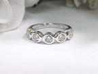 This is a 5 stone bezel set natural round diamond band in 14K white gold with a white background.