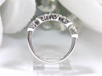 This is a 5 stone bezel set natural round diamond band in 14K white gold with a white background side view.