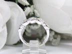 This is a 5 stone bezel set natural round diamond band in 14K white gold with a white background side view.