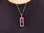 This is a women's 18ct total weight bi-color or watermelon tourmaline and diamond pendant in white gold shown on a ladies' neck.