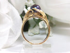 This a side view of a genuine black pearl ring in yellow gold from our estate collection fully restored to like new condition with a white gold background.