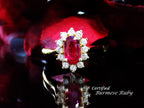 This is women's 1.46ct total natural GIA certified oval shape Burmese Ruby and diamond ring in 18K yellow gold shown with a black and red background. 