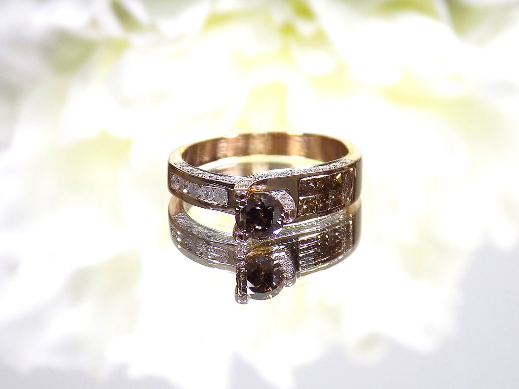 This is a very modern looking chocolate and white diamond ring in rose gold with white background.