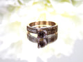This is a very modern looking chocolate and white diamond ring in rose gold with white background.