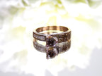 This is a very modern looking chocolate and white diamond ring in rose gold with white background.