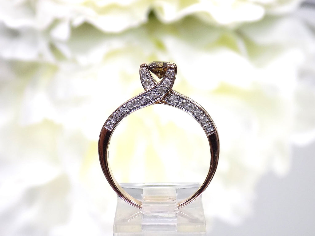 This is a very modern looking chocolate and white diamond ring in rose gold shown from the side.