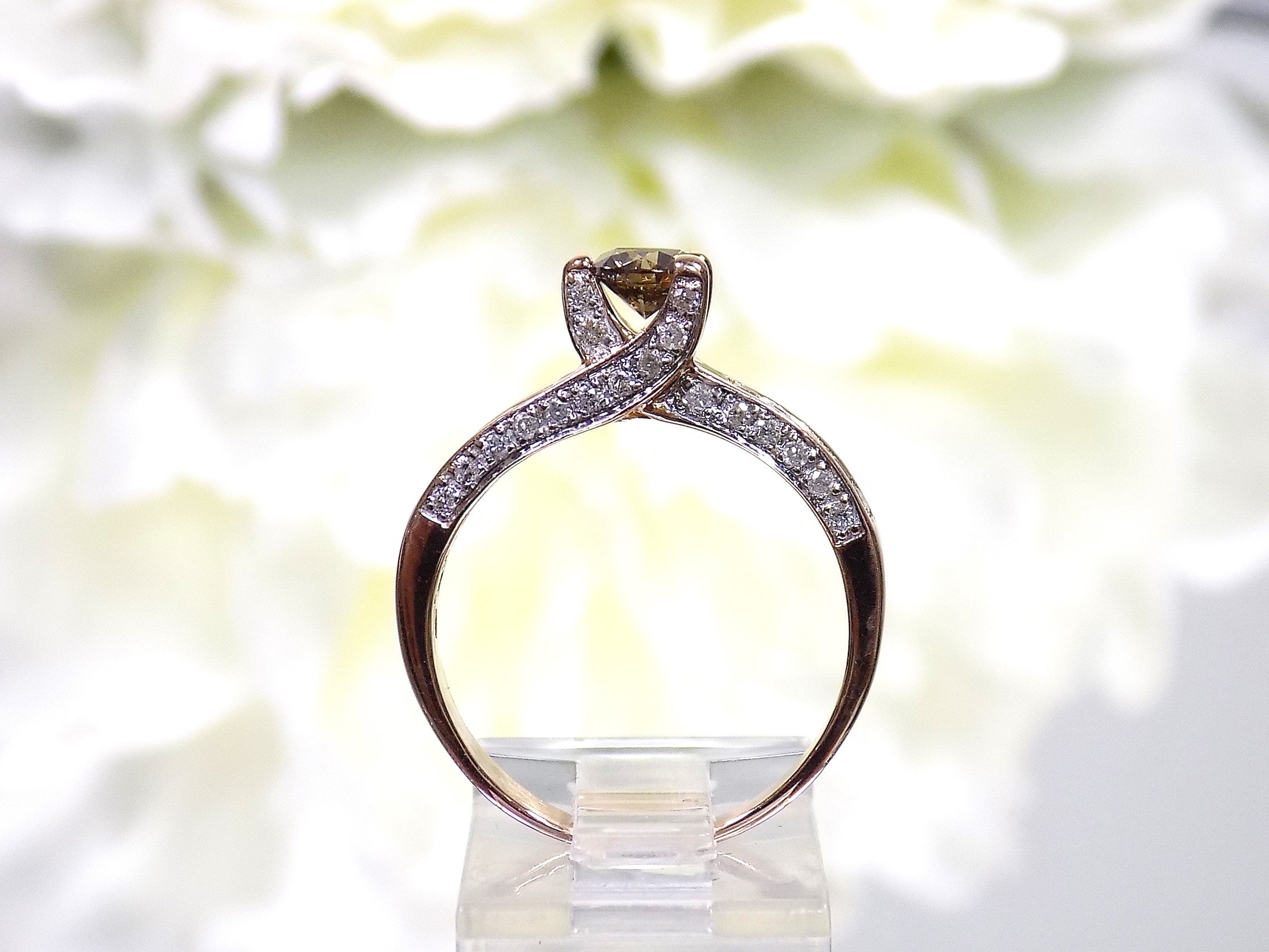This is a very modern looking chocolate and white diamond ring in rose gold shown from the side.