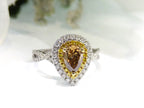 This is a 1.69ct total weight genuine natural pear shape chocolate diamond ring with canary yellow and white diamond accents in white gold with a white background.