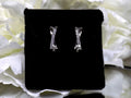 This is a pair of criss-cross huggie diamond earrings in white gold.