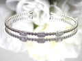 .25ct natural emerald cut and round diamond flex bracelet in 10K white gold.