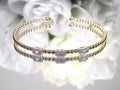 .25ct natural emerald cut and round diamond flex bracelet in 10K yellow gold.