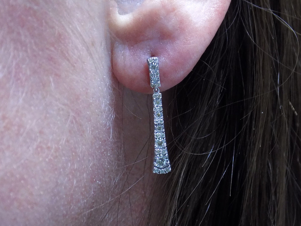 .33ct total weight natural diamond dangle earrings in 10K white gold on a ladies ear.