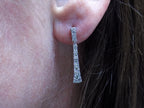 .33ct total weight natural diamond dangle earrings in 10K white gold on a ladies ear.