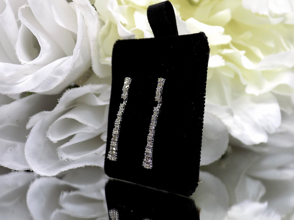 .33ct total weight natural diamond dangle earrings in 10K white gold. Side view.