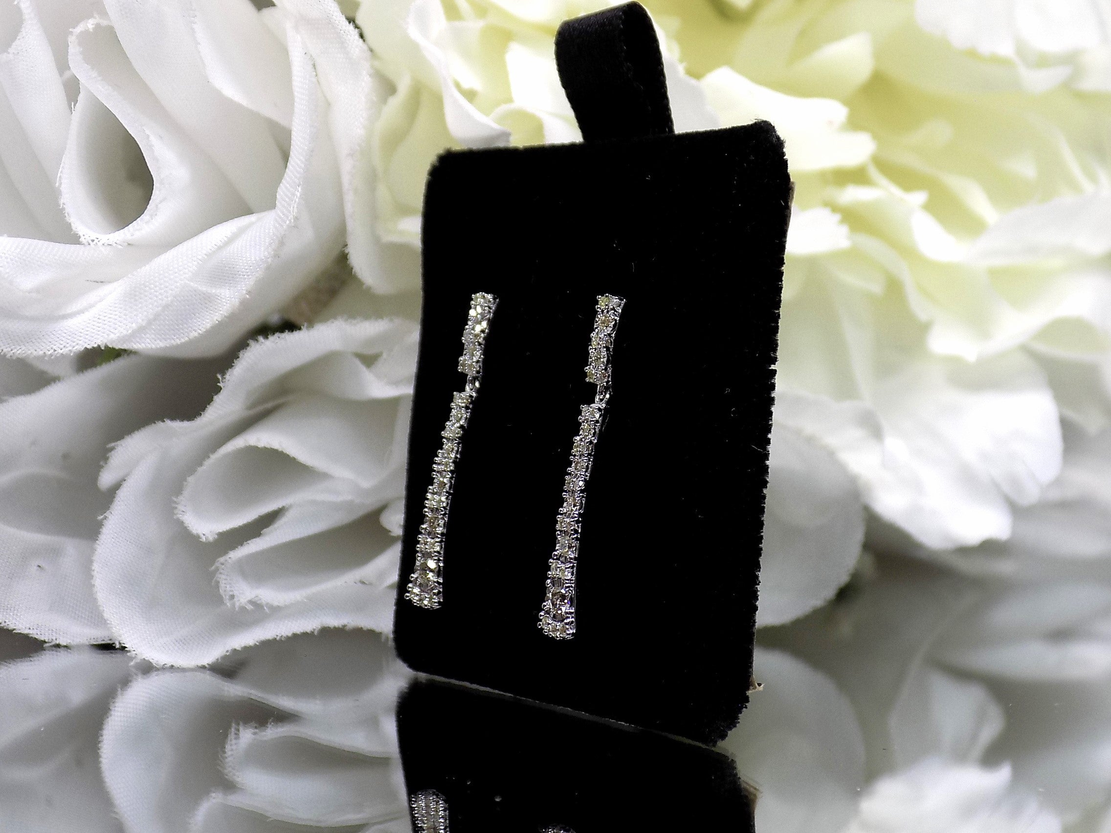 .33ct total weight natural diamond dangle earrings in 10K white gold. Side view.