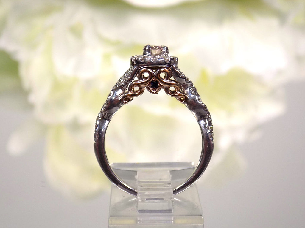 This is a side view of just the engagement ring that goes with a women's 2-piece wedding set which includes the engagement ring and matching band weighing 1.02ct in natural diamonds in white gold with rose gold accents on a white background