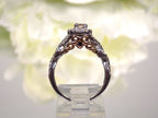 This is a side view of just the engagement ring that goes with a women's 2-piece wedding set which includes the engagement ring and matching band weighing 1.02ct in natural diamonds in white gold with rose gold accents on a white background