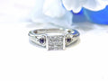 This is a Princess Cut Invisible Set Natural Diamond Ring with Round Sapphires in White Gold.